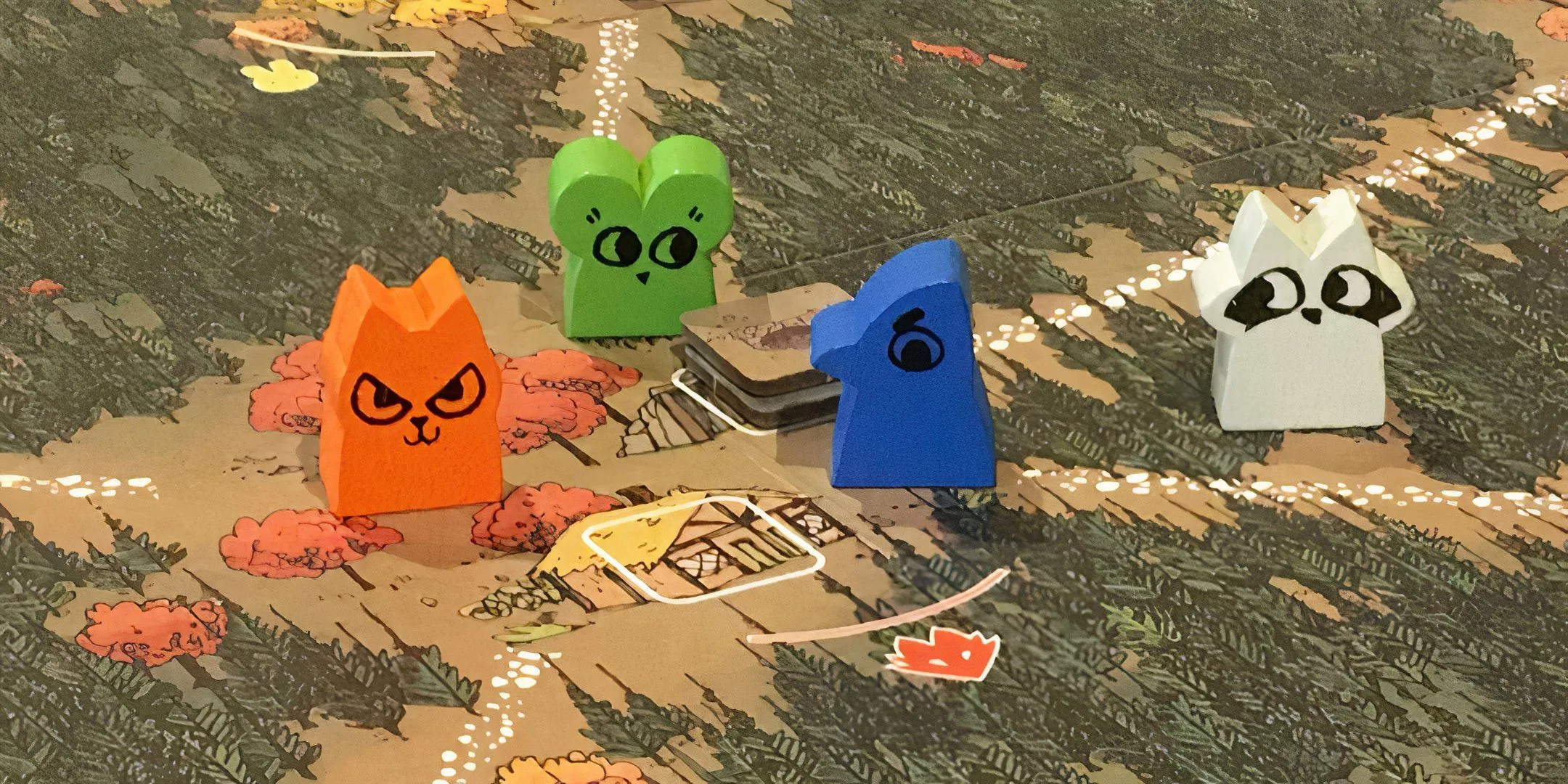 Bốn nhân vật thú rừng dạng meeple trên bản đồ game Root đầy màu sắc, đại diện cho các phe phái tranh giành lãnh thổ.