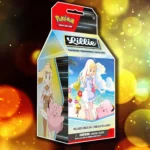 Hộp Premium Tournament Collection Lillie với thiết kế màu hồng pastel và hình ảnh nhân vật Lillie rạng rỡ, một trong những sản phẩm Pokemon TCG đáng giá sưu tầm.