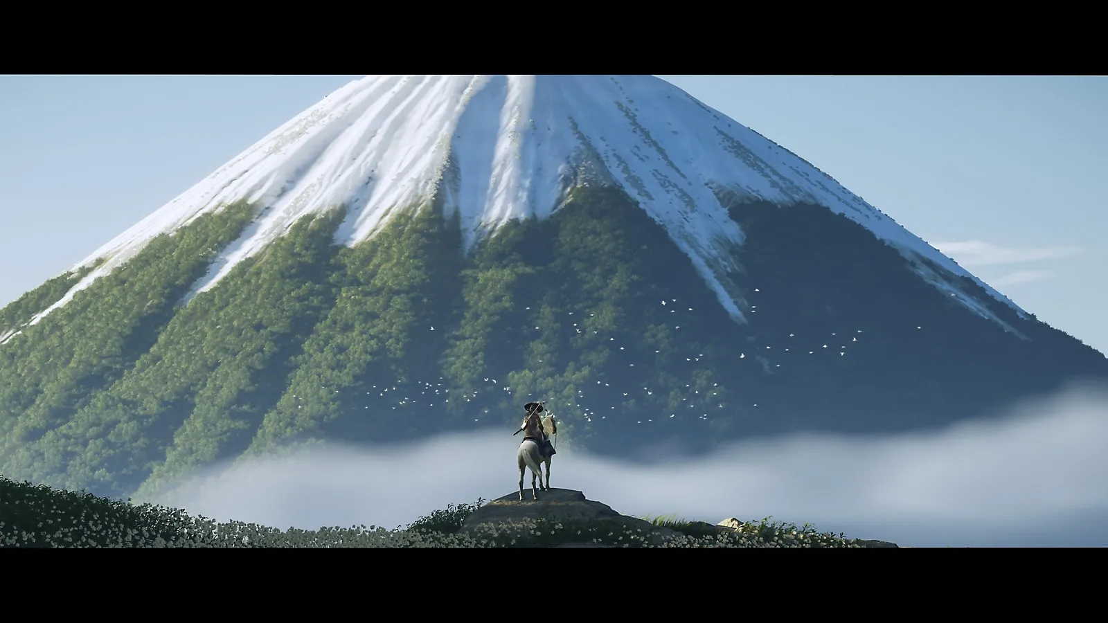 Atsu nhìn ra thung lũng từ đỉnh núi trong Ghost of Yotei